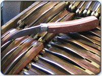 Assembled knives in a tray ready to be ground glazed and finished